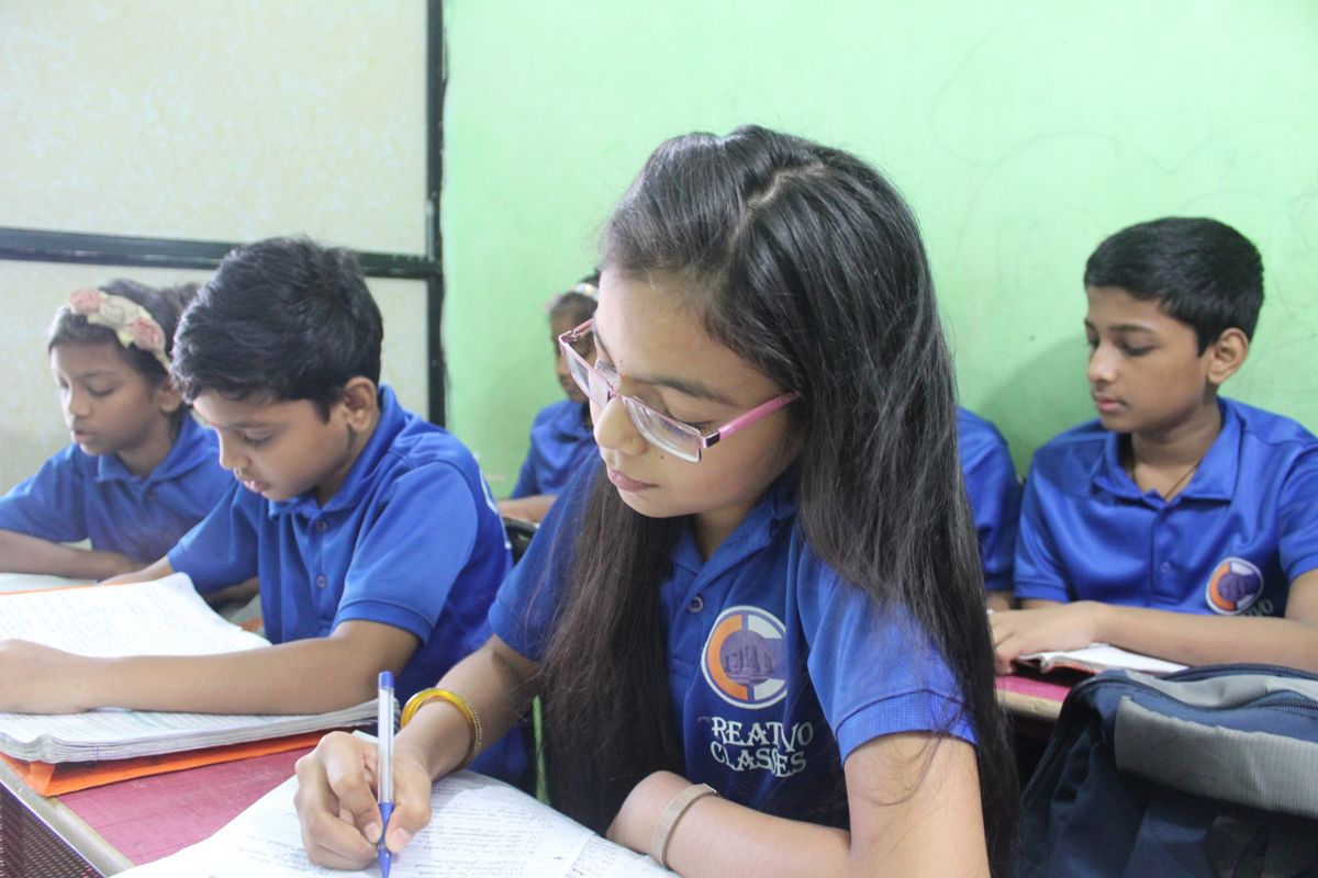 A Creativo Classes student writing in her notebook during class